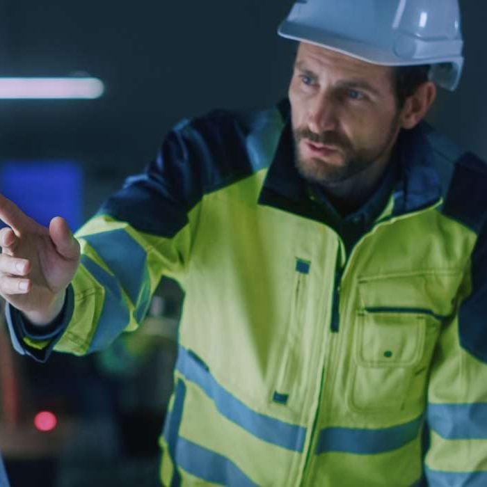 Two industrial workers planning smart safety on a computer screen.